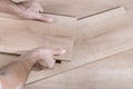 Installing laminate flooring in a room or office. Wooden parquet boards in the hands of a worker. Construction and Royalty Free Stock Photo