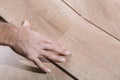 Installing laminate flooring in a room or office. Wooden parquet boards in the hands of a worker. Construction and Royalty Free Stock Photo