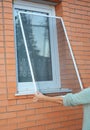 Installing mosquito net, mosquito wire screen on brick house wi