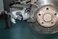 Installing a new brake caliper on the rear left wheel of the car