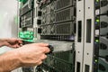 Installing a new server in the server datacenter rack. Repair of powerful Internet equipment. Engineering work in the server room