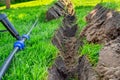 Installing a pop-up sprinkler in the lawn, close-up. Grass Irrigation Integration Royalty Free Stock Photo