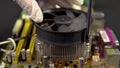 Installing a processor cooler on the motherboard. CPU cooling system on pc. View of the disassembled computer. Royalty Free Stock Photo