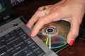 Installing program from DVD to laptop computer - Image Royalty Free Stock Photo