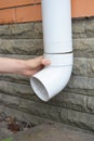 Installing rain gutter downpipe. Contractor hands repair rain gutter downspout pipe. Guttering, Gutters, Plastic Guttering