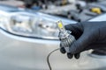 Installing replacement new modern halogen led car headlight bulb Royalty Free Stock Photo