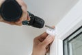 Installing roller blind on a window. Royalty Free Stock Photo