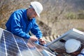 Installing solar photovoltaic panel system on roof of house Royalty Free Stock Photo