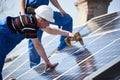 Installing solar photovoltaic panel system on roof of house Royalty Free Stock Photo