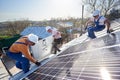 Installing solar photovoltaic panel system on roof of house Royalty Free Stock Photo