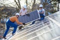 Installing solar photovoltaic panel system on roof of house Royalty Free Stock Photo