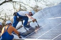 Installing solar photovoltaic panel system on roof of house Royalty Free Stock Photo