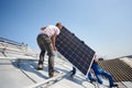 Installing solar photovoltaic panel system on roof of house Royalty Free Stock Photo