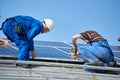 Installing solar photovoltaic panel system on roof of house Royalty Free Stock Photo