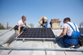 Installing solar photovoltaic panel system on roof of house Royalty Free Stock Photo