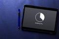 Installing update with circle load percentage waiting indicator concept on tablet screen with blue pen on blue pattern Royalty Free Stock Photo