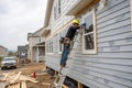 Installing vinyl siding on a new house Royalty Free Stock Photo