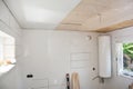 Installing white PVC Ceiling Boards in the new bathroom