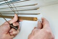 Installing wooden blinds.