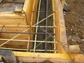 Installing wooden forms for pouring the Foundation concrete trench reinforced with reinforcement made of fiberglass Royalty Free Stock Photo