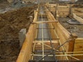 Installing wooden forms for pouring the Foundation concrete trench reinforced with reinforcement made of fiberglass Royalty Free Stock Photo