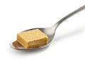 Instant chicken broth cube in a spoon