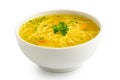 Instant chicken noodle soup in a white ceramic bowl isolated on white. Parsley garnish