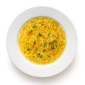 Instant chicken noodle soup in a white ceramic soup plate isolated on white. Top view. Chopped parsley