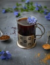 Instant chicory root drink in glass on gray concrete background