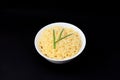 Instant Chinese curly noodles in white bowl on black background. Selective focus. Asian food concept. Unhealthy eating Royalty Free Stock Photo