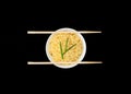 Instant Chinese curly noodles in white bowl with wood sticks on black background. Selective focus. Asian food concept Royalty Free Stock Photo