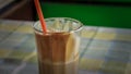 Instant coffe in a glass with a red straw Royalty Free Stock Photo