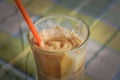 Instant coffe in a glass with a red straw Royalty Free Stock Photo