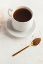 Instant coffee in a Golden spoon and a mug of black coffee. Concept of instant coffee birthday celebration. July 24 Royalty Free Stock Photo