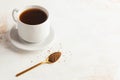 Instant coffee in a Golden spoon and a mug of black coffee. instant coffee birthday celebration. Copy space. July 24 Royalty Free Stock Photo