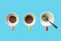 instant coffee powder in two ceramic cup with colorful handle and empty one cup with silver teaspoon isolated on blue background Royalty Free Stock Photo