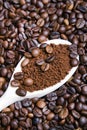 Instant coffee in spoon on coffee beans Royalty Free Stock Photo