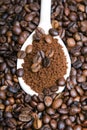 Instant coffee in spoon on coffee beans Royalty Free Stock Photo