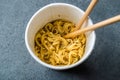 Instant Curry Flavored Ramen Noodles served with Chopsticks. in Plastic Cup Royalty Free Stock Photo