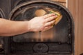 Instant detergent action on carbon deposits on the fireplace window. Removing tar and carbon deposits by hand and sponge Royalty Free Stock Photo