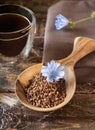 Instant granules, flowers of chicory and coffee alternative drink on wooden table Royalty Free Stock Photo