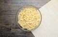 Instant noodle in the glass bowl on the wooden table Royalty Free Stock Photo