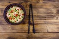 Instant noodle with shrimps, red pepper and green onion in a ceramic bowl. Japanese food. Top view Royalty Free Stock Photo