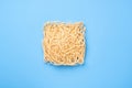 Instant noodles on blue background, top view. Ramen