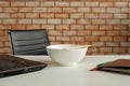 Instant noodles in a bowl near laptop on white working desk in office Royalty Free Stock Photo