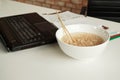 Instant noodles in a bowl near laptop on white working desk in office Royalty Free Stock Photo