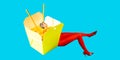 Instant noodles in a box with female legs in red rights and eels on blue background. Lunch time. Contemporary art