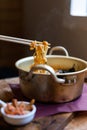 Instant noodles in chopstick on aluminum pot Royalty Free Stock Photo