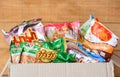 Instant noodles in package on box and wooden background - dry food non perishable storage goods in kitchen home or for donations