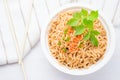 Instant noodles in paper bowl on white wooden background Royalty Free Stock Photo